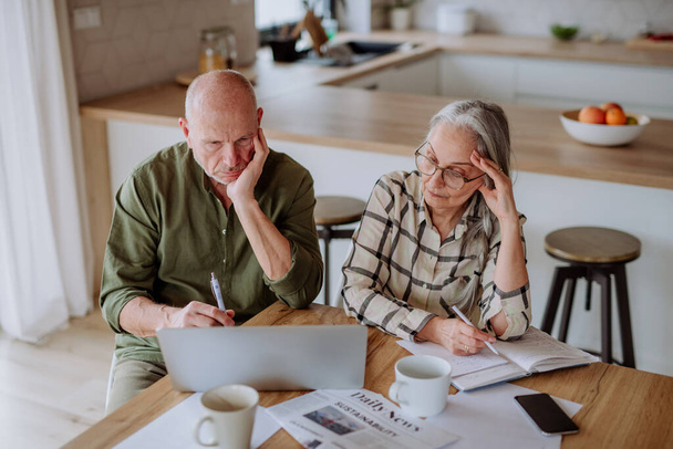 Stressed senior couple calculate expenses or planning budget together at home. - Valokuva, kuva