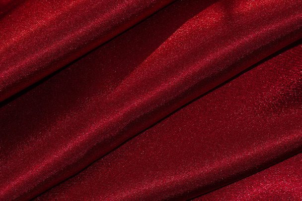 Close up of deep dark red draped textile material. - Photo, Image