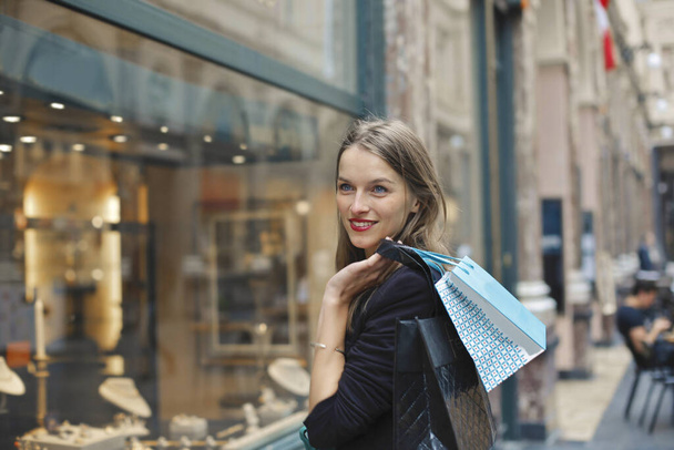 young woman with shopping bags in the city - Foto, imagen