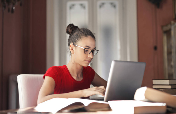 portrait of young woman while working with a computer - Photo, image