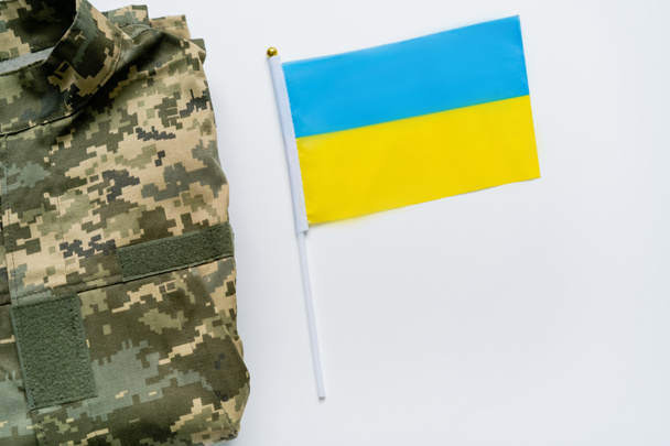 Top view of military uniform and ukrainian flag on white background - Photo, Image
