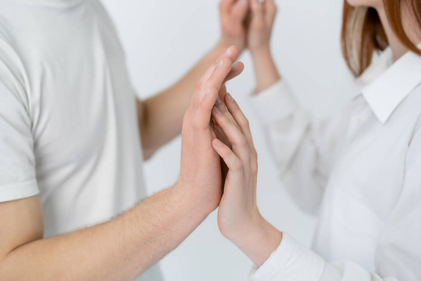 Cropped view of blurred couple touching hands isolated on white  - Foto, immagini