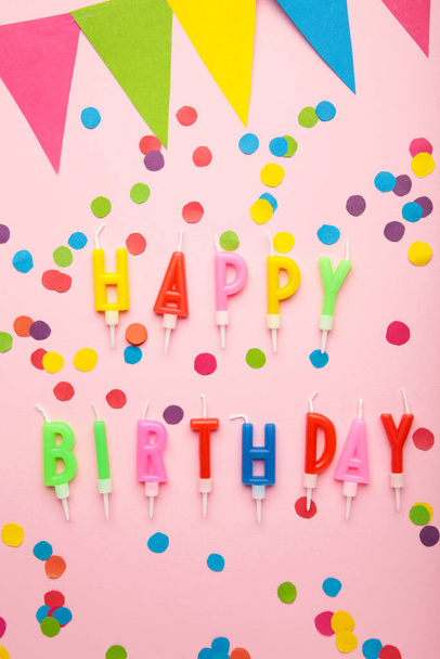 Text Happy Birthday with birthday asseccories, candles and confetti on pink background. Top view. - Foto, immagini