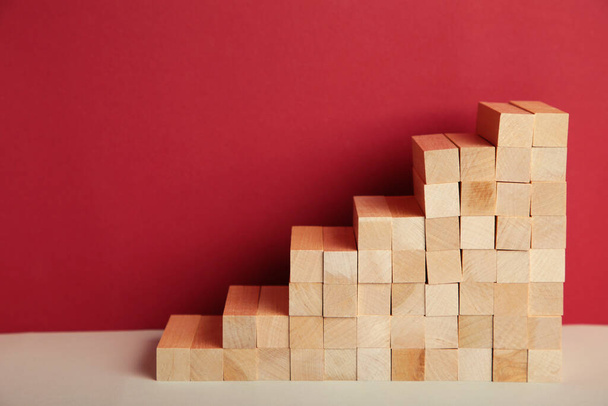 Stairway of wood blocks on red background. Business concept. Top view - Фото, изображение