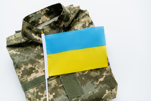 Top view of ukrainian flag on military uniform on white background  - Zdjęcie, obraz