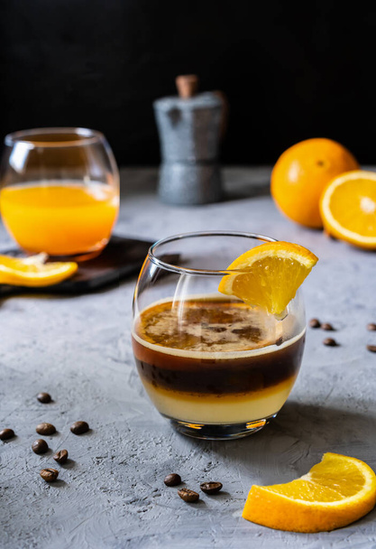 Coffee with orange juice and caramel syrup - 写真・画像