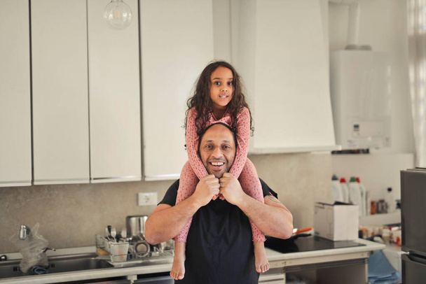 portrait by father and daughter in the kitchen - Foto, Bild