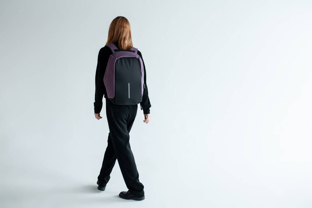 stylish hipster person holding modern backpack bag on white background - Foto, afbeelding