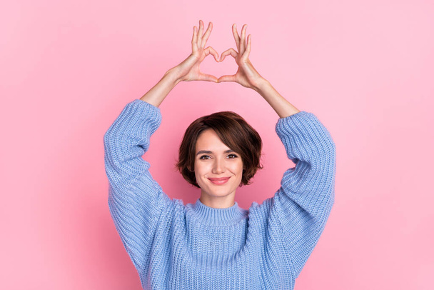 Portrait of gorgeous positive lady arms make heart symbol above head isolated on pink color background - Фото, изображение