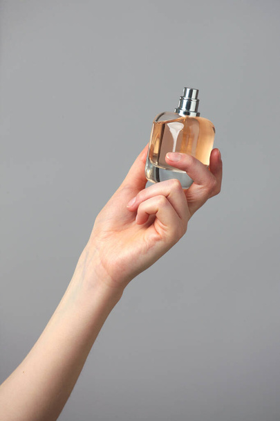 Perfume bottle in woman hands - 写真・画像