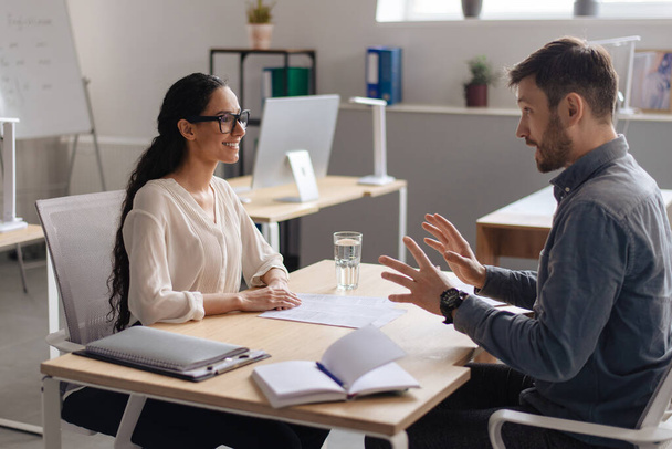 HR manager interviewing potential employee at modern company office. Personnel recruitment, corporate headhunting - Photo, Image