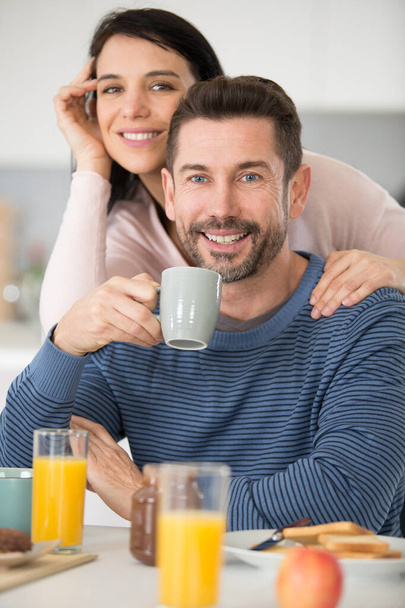middle aged couple making breakfast and having fun - 写真・画像
