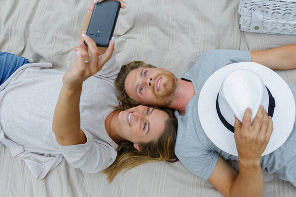 young couple taking selfie on the bed - Foto, Imagem