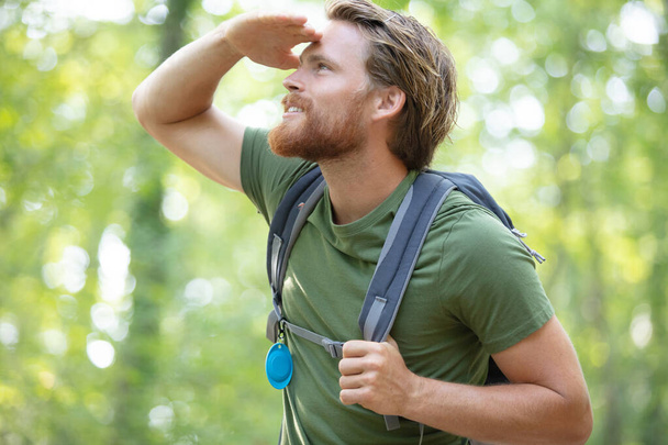 hiker man with mountain backpacker looking far away - Valokuva, kuva