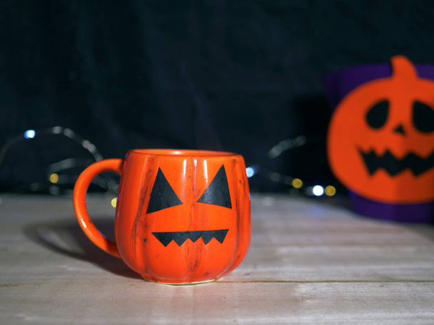 Halloween pumpkin drink with cream topping on dark background  - Foto, afbeelding