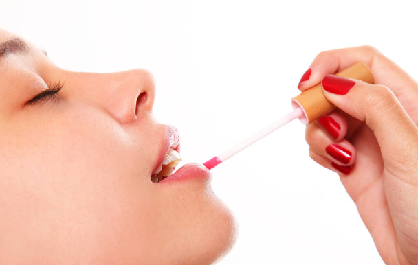 Woman applying lipstick - Zdjęcie, obraz