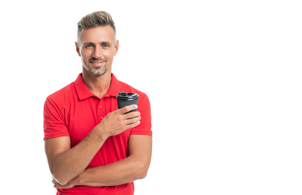 Happy guy in casual red tshirt holding disposable cup with takeaway tea isolated on white - Foto, imagen