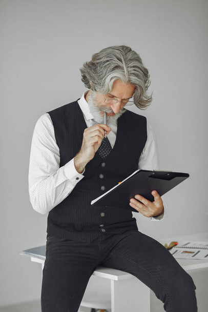 Handsome pensive mature businessman in the office - Fotoğraf, Görsel
