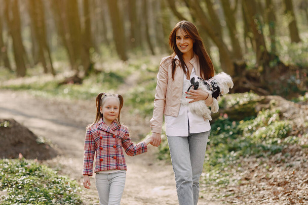 Mother with daughter in a spring forest with dog - Fotografie, Obrázek
