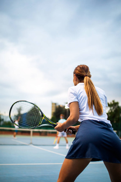 Portrait of happy fit young woman playing tennis at summer. People sport healthy lifestyle concept - Foto, immagini