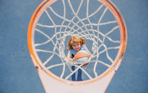 Kid playing basketball with basketball ball. - Φωτογραφία, εικόνα