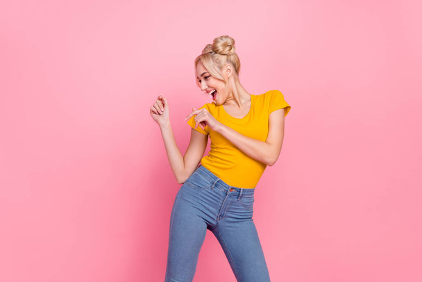 Photo of cute young blond lady dance wear t-shirt jeans isolated on pink color background - Fotografie, Obrázek