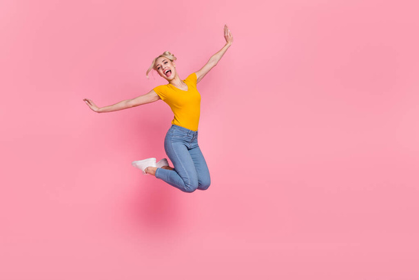 Full size photo of attractive pretty woman jumping fooling around enjoy free summer time isolated on pink color background - Фото, изображение