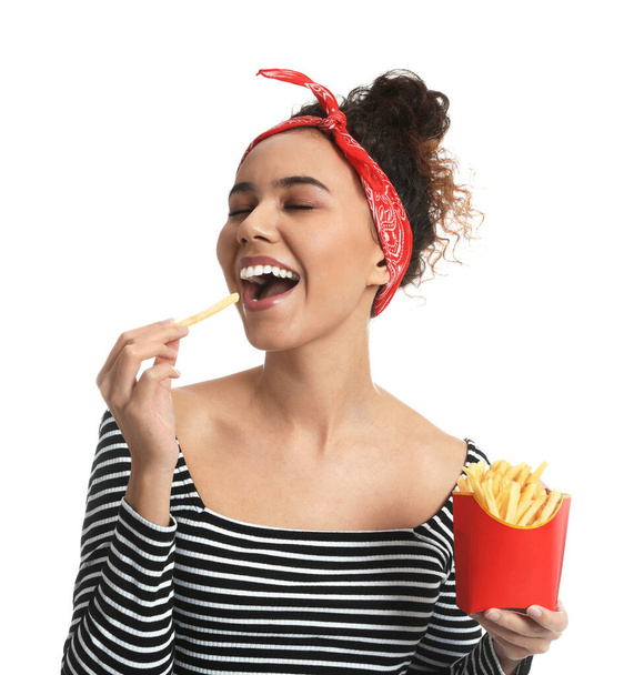 African American woman eating French fries on white background - Zdjęcie, obraz