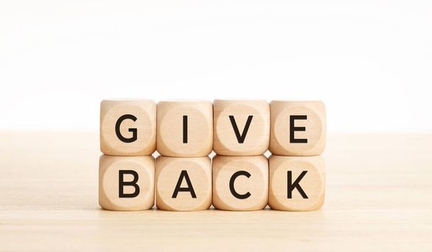 Give back message on wooden blocks. Copy space - Foto, Imagem