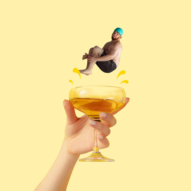 Contemporary art collage. Funny looking man in swimming cap jumping into tasty cocktail isolated over yellow background - Foto, Imagem