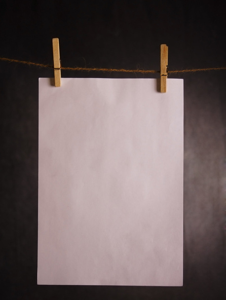 A piece of paper hanging on cord - 写真・画像