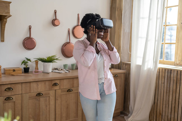 Contented african woman in pink clothes in VR galsses - Photo, Image
