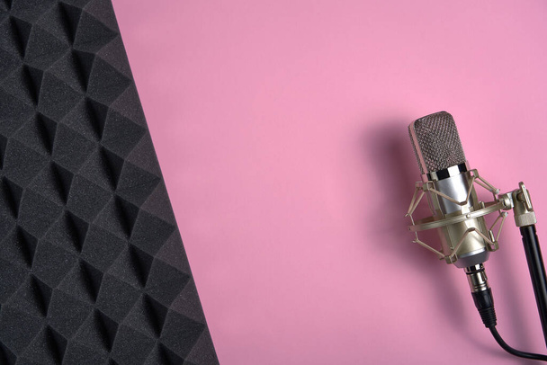 Microphone on pink background with copy space and acoustic foam panel - Fotó, kép