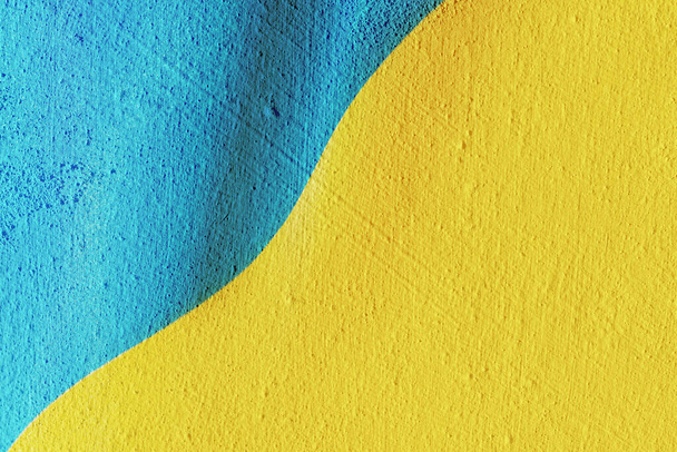 National Yellow and Blue Flag of Ukraine painted on beautiful textured concrete wall. Copy space. - Photo, image