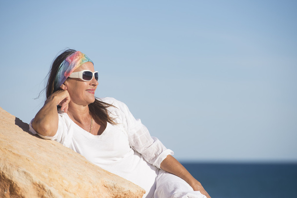 Relaxed friendly mature woman at beach vacation - Fotoğraf, Görsel