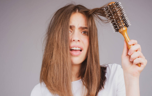 Closeup hair loss, hair fall in hairbrush, stress problem of woman with a comb. - Фото, зображення
