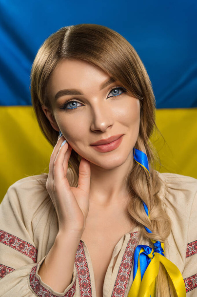 Cute Ukrainian woman in a patriotic image - 写真・画像