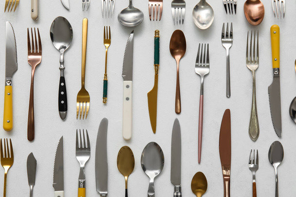 Many different cutlery on light background, top view - Photo, Image