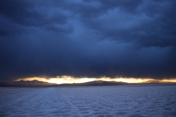 Storm at salt flat desert on sunset - Фото, изображение