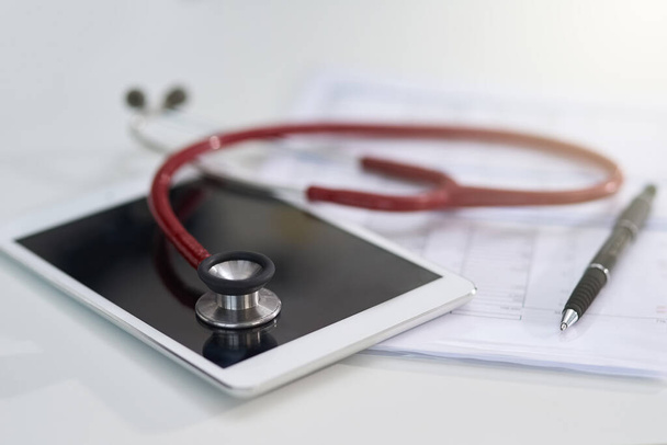 Its important to log your medical history with your practitioner. Cropped shot of a stethoscope on a tablet. - Fotó, kép