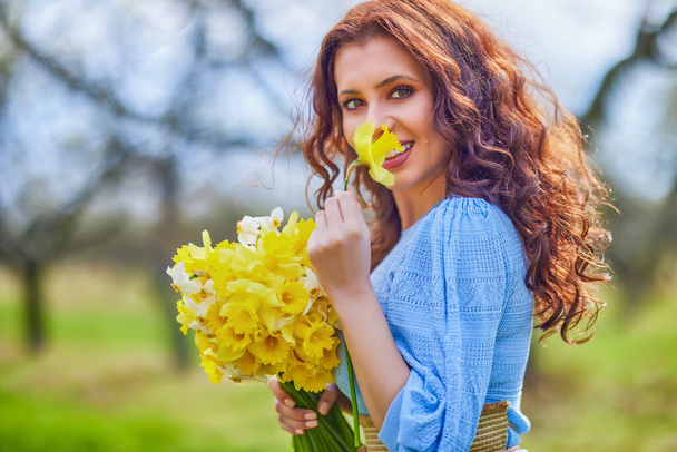 portrait of a beautiful brunette woman in spring nature. - Фото, изображение