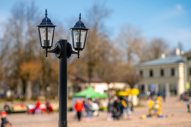 vintage lantern pole close-up isolated on a defocused city background, background with copy space - Фото, зображення