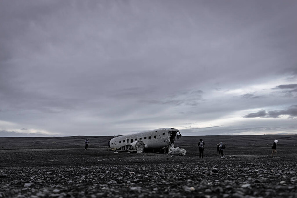 Wreck of an airplane with unrecognizable tourists, wide angle - Photo, Image