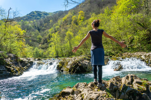 A young woman enjoying the Sella river between the Tornin a la Olla de San Vicente, near Cangas de Onis. Asturias. Spain - Photo, image
