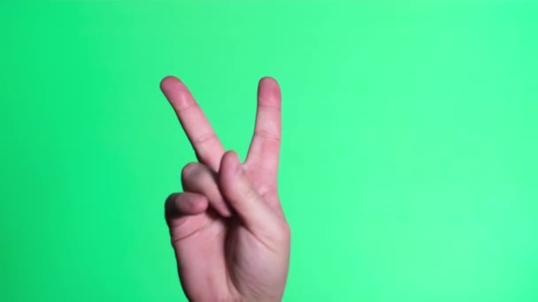Two fingers up on the chromakey screen. Gesture of victory - Imágenes, Vídeo