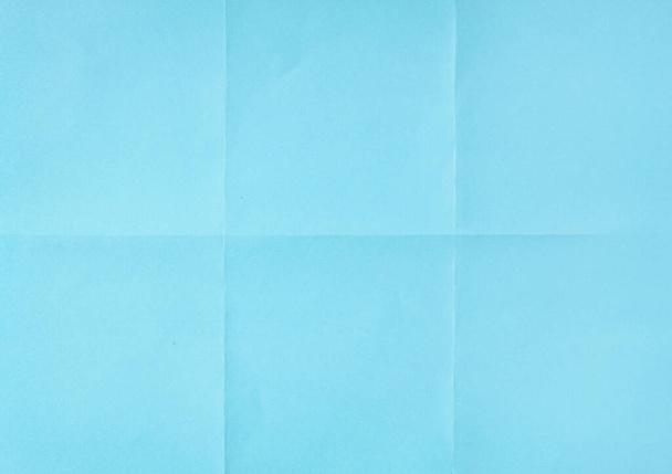 Blauw verfrommeld ontvouwen papier vel textuur achtergrond. Papier gevouwen in zes. Volledig frame - Foto, afbeelding