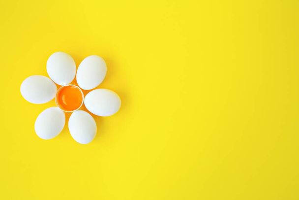 egg white against yellow background, one egg Easter card with copy space for text. Happy Easter concept. Preparation for the holiday. pattern, omelette cooking - Fotoğraf, Görsel