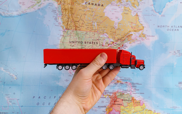 Trucking in United States of America concept. Model truck toy over map. - Photo, Image