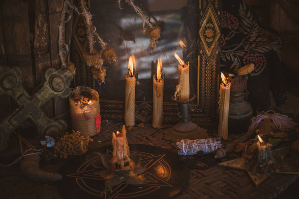 Magical illustration, esoteric concept. Candles for clean dark energy. Wicca and pagan stuff on a table - Foto, Imagen