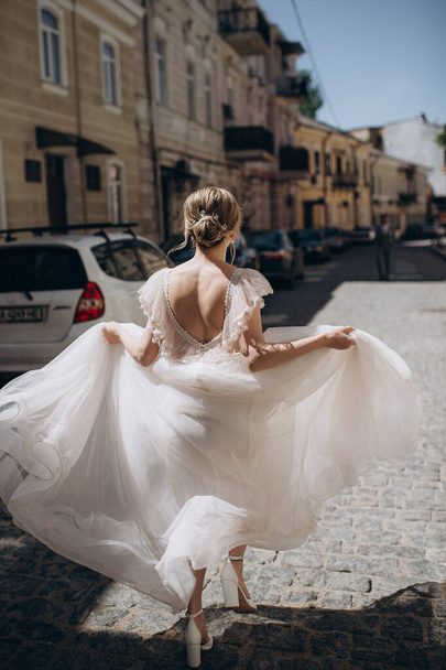 sposa in un abito da sposa a piedi lungo la strada - Foto, immagini